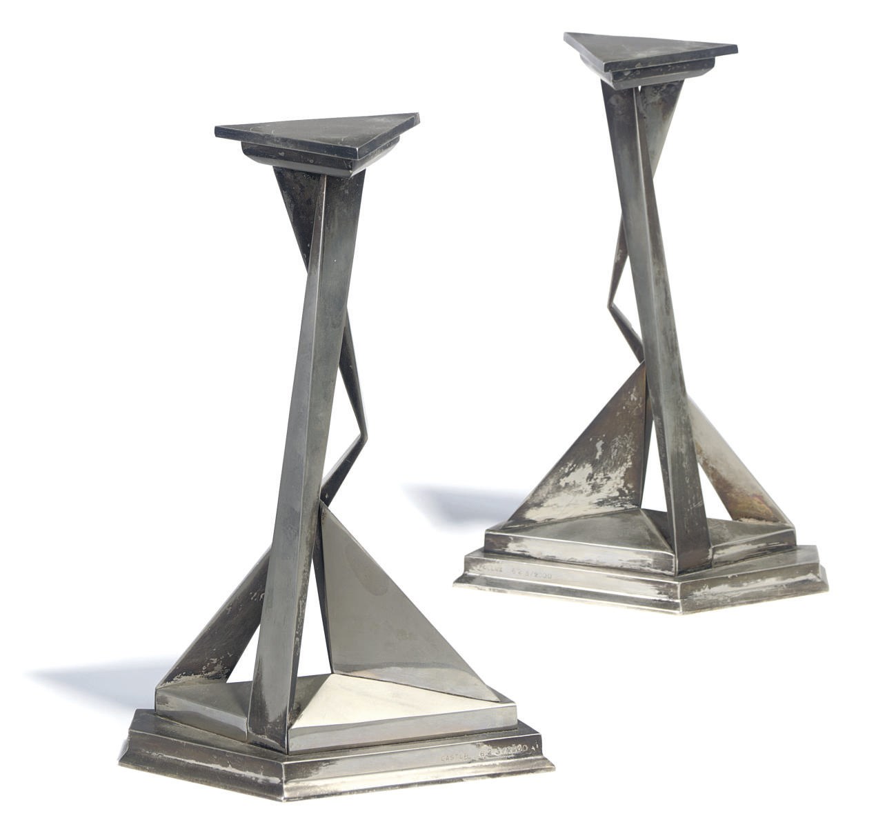 A PAIR OF L'IMMORTALITI DE CASTOR ET POLLUX SILVERED METAL CANDLESTICKS