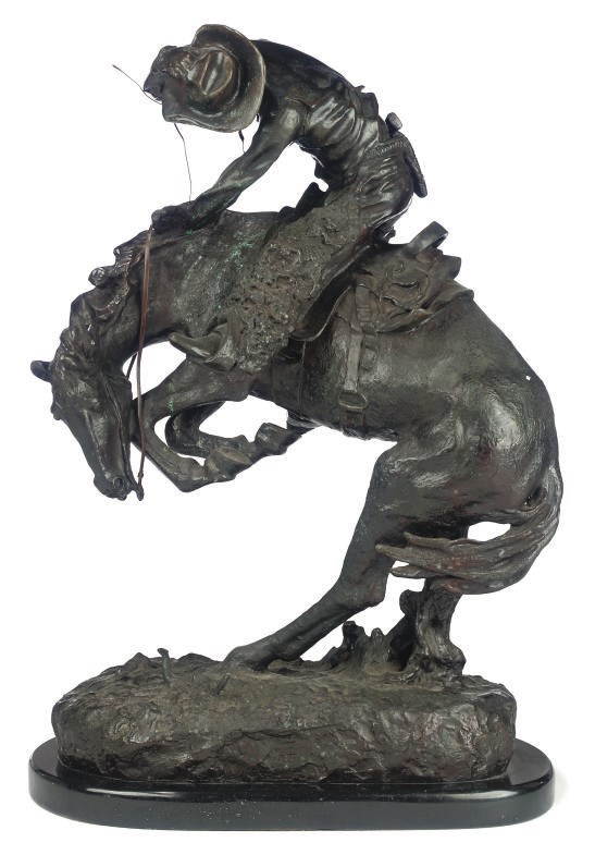 A BRONZE GROUP OF A COWBOY ON HORSEBACK
