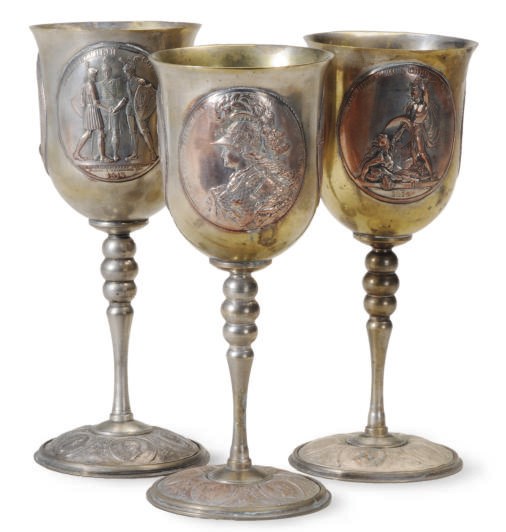 FIVE SILVERED METAL AND BRASS COMMEMORATIVE GOBLETS,