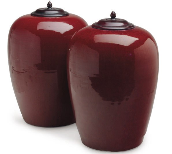 A PAIR OF CHINESE COPPER RED GLAZED JARS AND TWO WOOD COVERS,