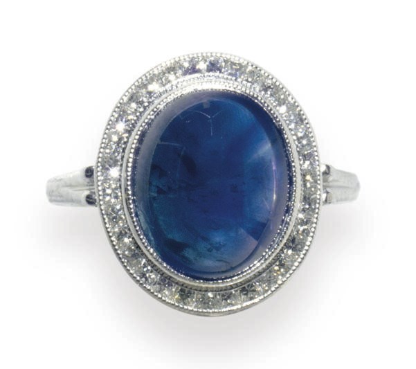 A SAPPHIRE, DIAMOND AND PLATINUM RING