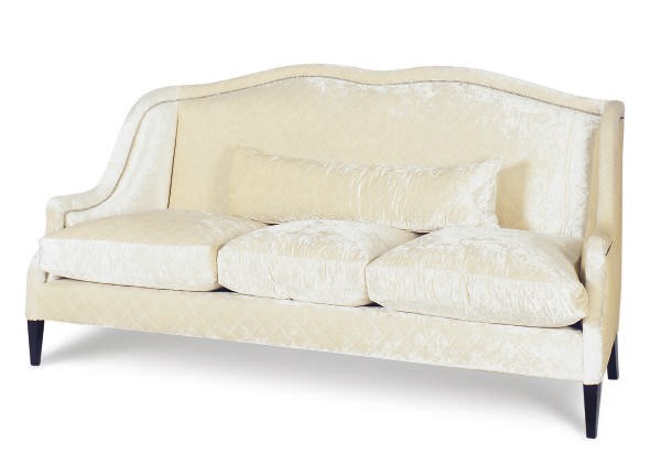 AN EBONIZED AND QUILTED SILK VELVET UPHOLSTERED SOFA,