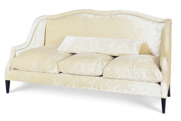AN EBONIZED AND QUILTED SILK VELVET UPHOLSTERED SOFA,