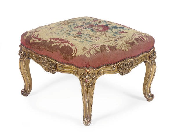 A FRENCH GILTWOOD AND UPHOLSTERED SERPENTINE STOOL,