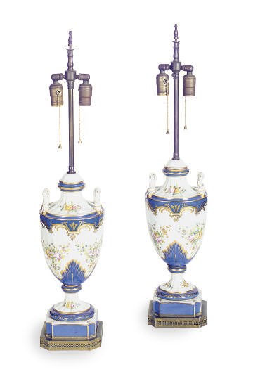 A PAIR OF FRENCH PORCELAIN COVERED URNS MOUNTED AS LAMPS,