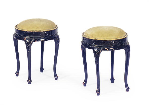 A PAIR OF EBONIZED AND UPHOLSTERED LOW STOOLS,