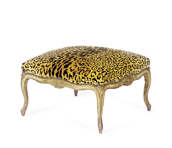 A GILTWOOD AND UPHOLSTERED OTTOMAN,