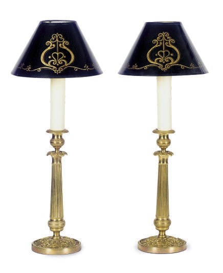 A PAIR OF GILT-METAL CANDLESTICKS MOUNTED AS TABLE LAMPS,