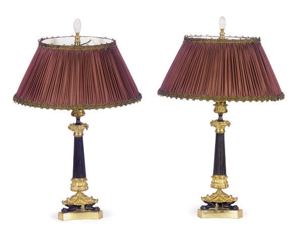 A PAIR OF FRENCH PATINATED AND GILT-BRONZE CANDLESTICKS,