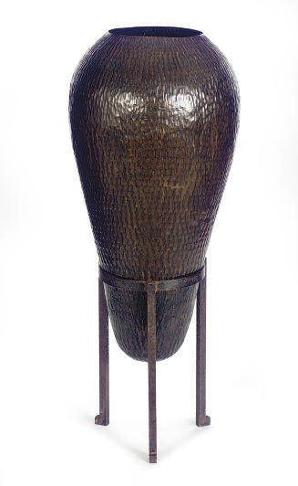 A TEXTURED COPPER OVOID-FORM VASE ON STAND,