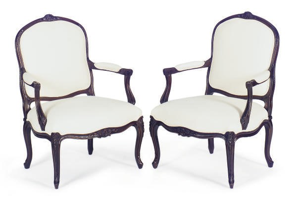 A PAIR OF STAINED MAHOGANY AND WHITE CANVAS UPHOLSTERD FAUTEUILS,