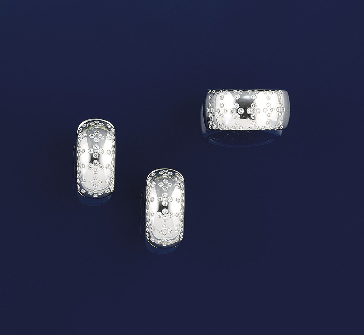A pair of diamond earrings and a ring