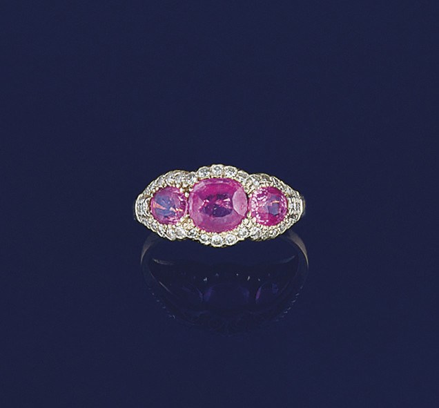 A pink sapphire and diamond triple cluster ring