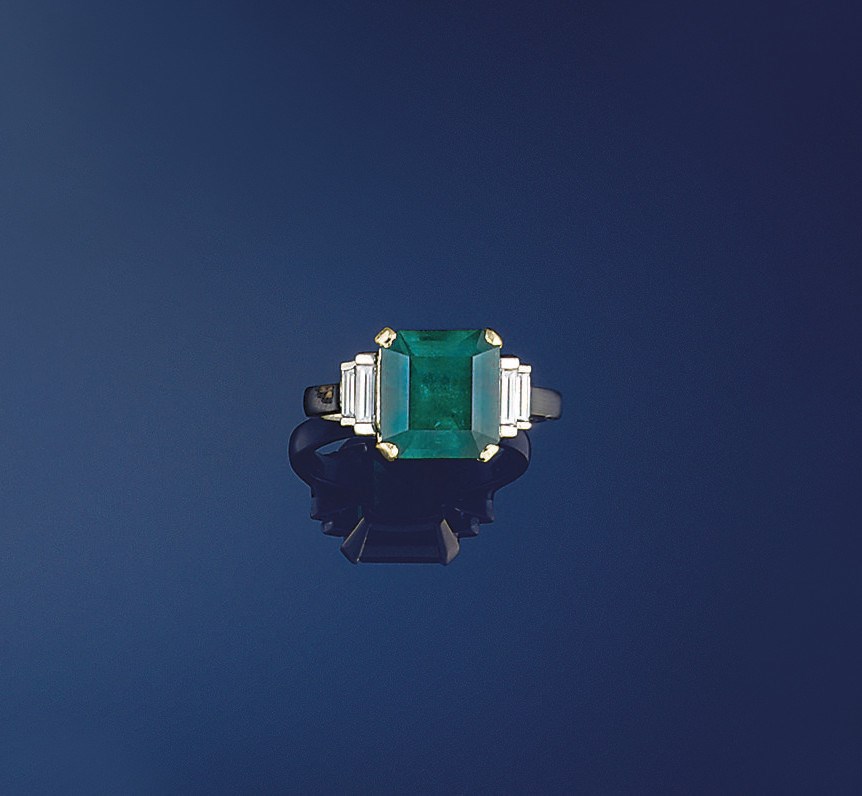 An emerald and diamond ring