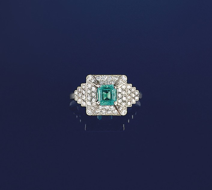 An early 20th century emerald and diamond ring