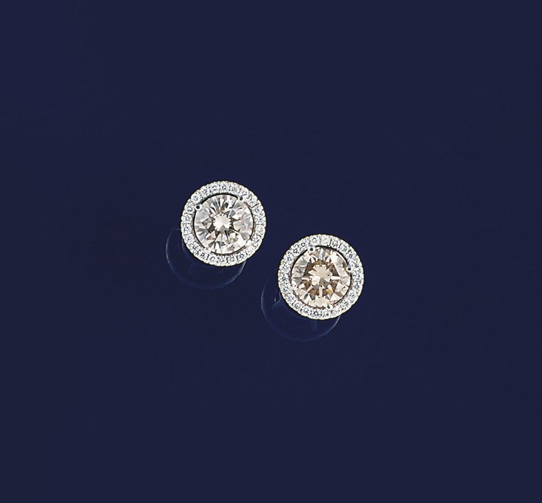 A pair of coloured diamond and diamond earstuds