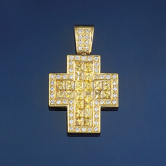A yellow sapphire and diamond cross pendant