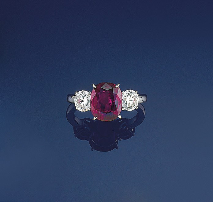 A ruby and diamond three stone ring