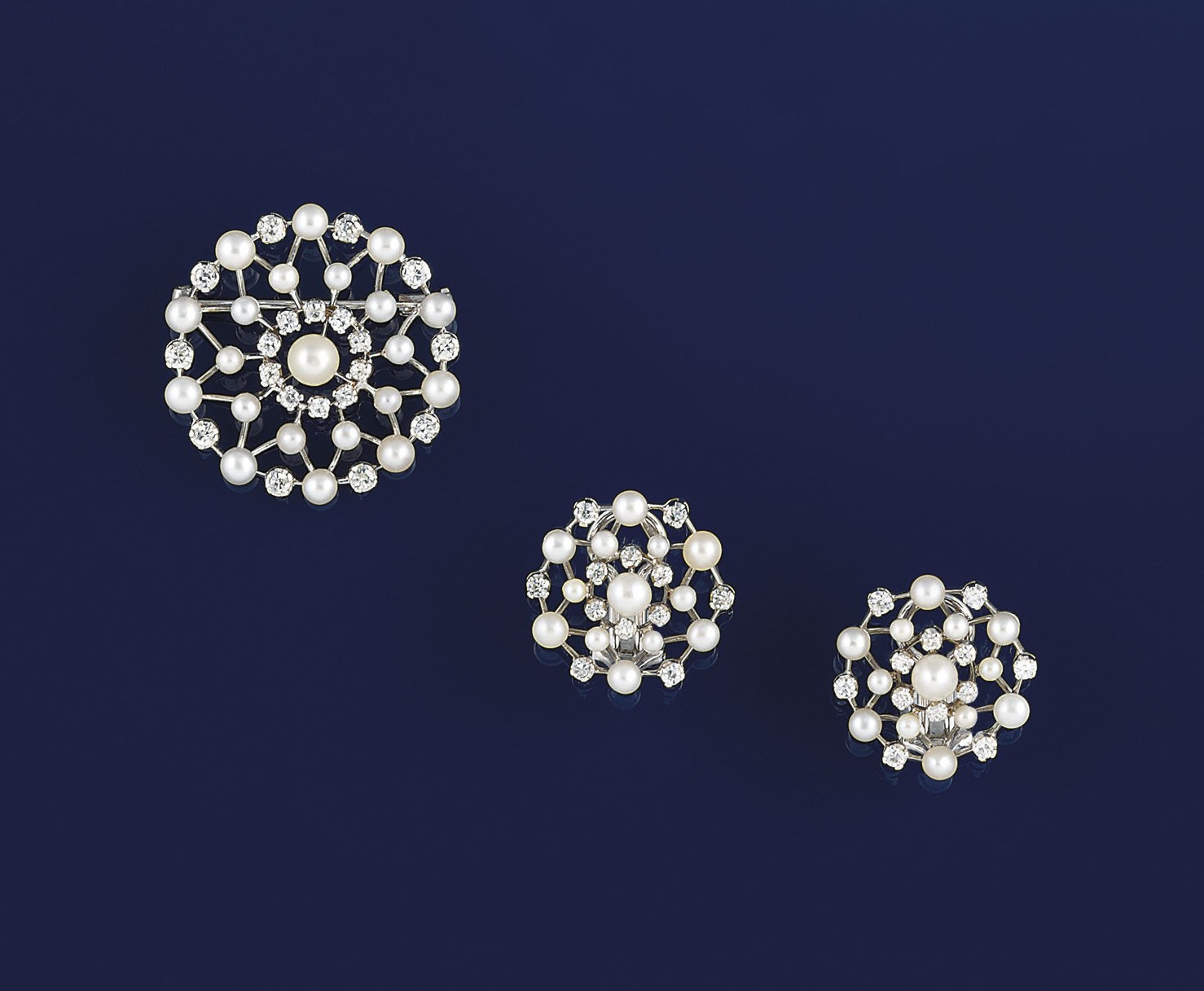 A pearl and diamond brooch and earclips