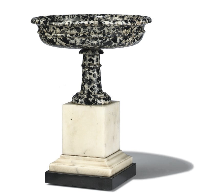 AN ITALIAN BIANCO E NERO GRANITE TAZZA ON WHITE MARBLE STAND