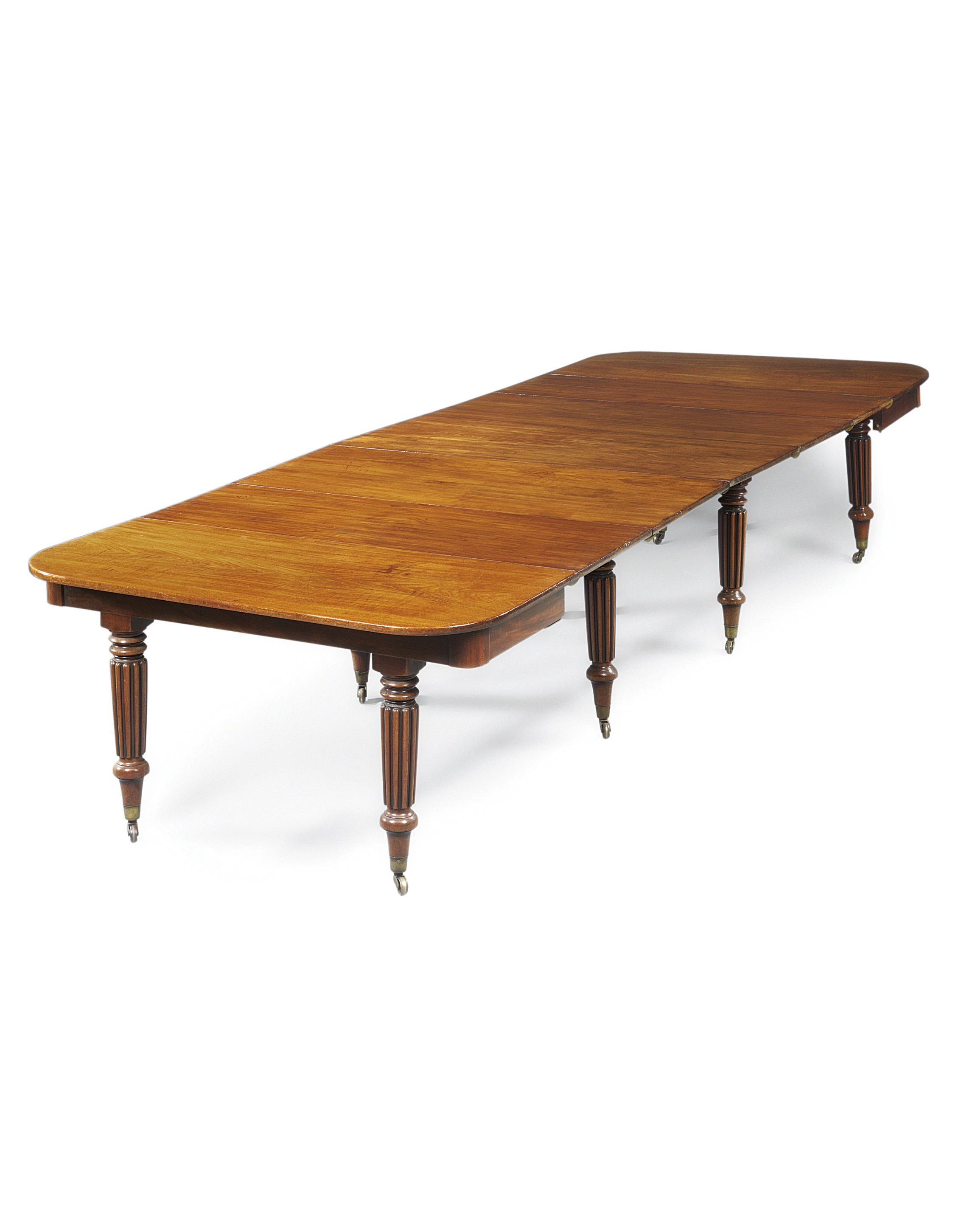 A REGENCY MAHOGANY EXTENDING DINING-TABLE