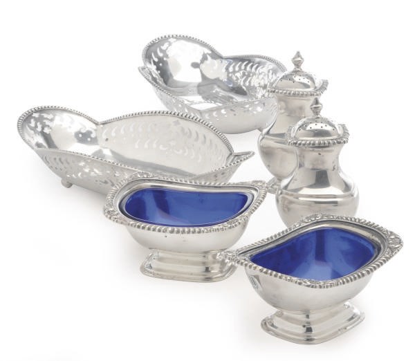 A PAIR OF AMERICAN SMALL SILVER BREAD BASKETS, A PAIR OF SALT CELLARS AND GLASS LINERS, AND A PAIR OF CASTERS,