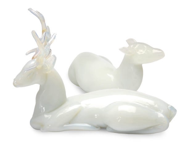 AN OPALINE GLASS MODEL OF A RECUMBANT STAG AND A DOE,