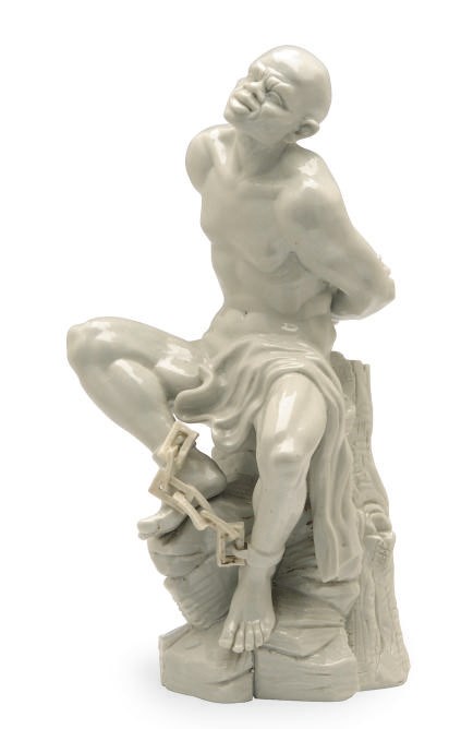A PORCELAIN SEATED SLAVE IN CHAINS,