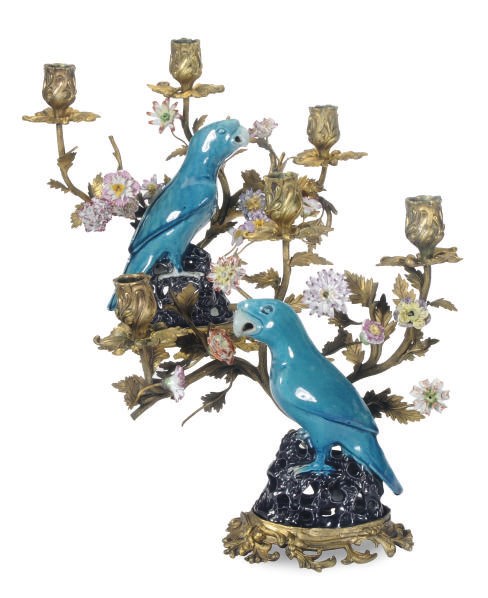 A PAIR OF GILT-METAL METAL PORCELAIN FLOWER ENCRUSTED THREE-LIGHT CANDLEABRA MOUNTED WITH CHINESE EXPORT STYLE PORCELAIN PARROTS,