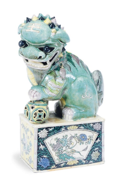 A CHINESE GREEN, AUBERGINE AND YELLOW GLAZED BUDDHISTIC LION,