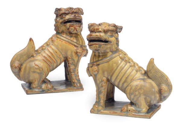 A PAIR OF CHINESE YELLOW-GLAZED EARTHENWARE MODELS OF BUDDHISTIC LIONS,