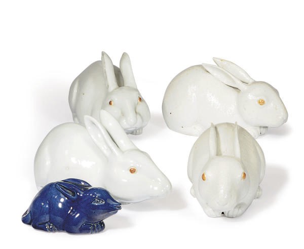TWO PAIRS OF PORCELAIN WHITE GLAZED MODELS OF RABBITS AND A SMALLER BLUE GLAZED MODEL OF A RABBIT,