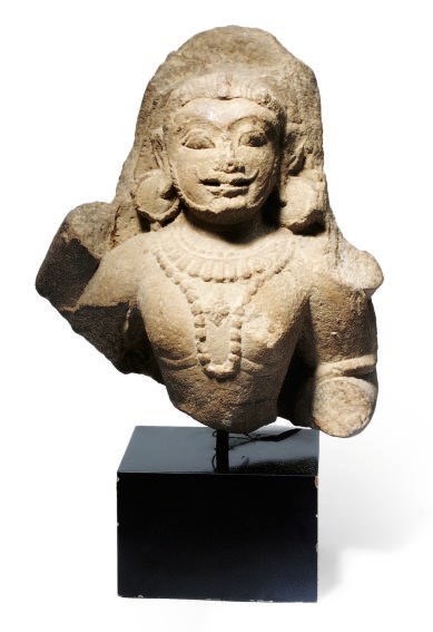 AN INDIAN SANDSTONE FRAGMENT OF A DEITY,