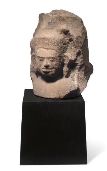 A KHMER SANDSTONE FRAGMENT OF A RELIEF OF A MALE DEITY,