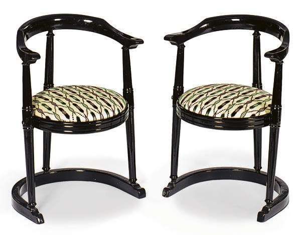 A PAIR OF EBONIZED LOW ARMCHAIRS,