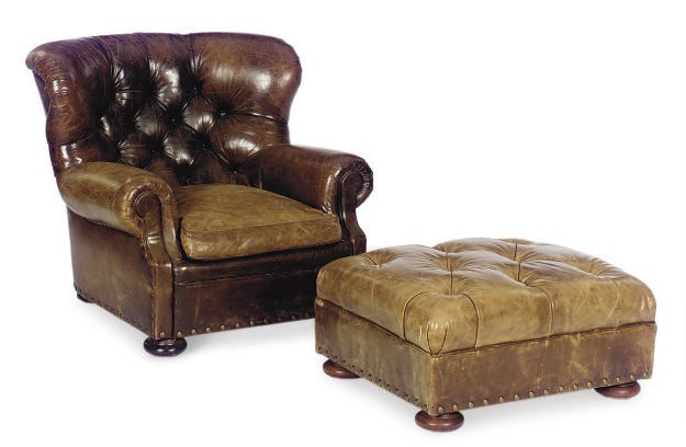 A BUTTON-TUFTED BROWN LEATHER ARMCHAIR,