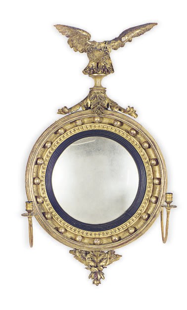 A REGENCY GILTWOOD AND PART-EBONIZED FIGURAL CONVEX GIRANDOLE MIRROR,