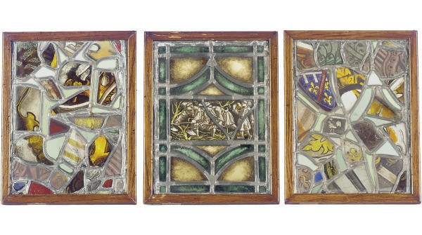 A GROUP OF SEVEN FRAMED STAINED GLASS WINDOW PANELS,