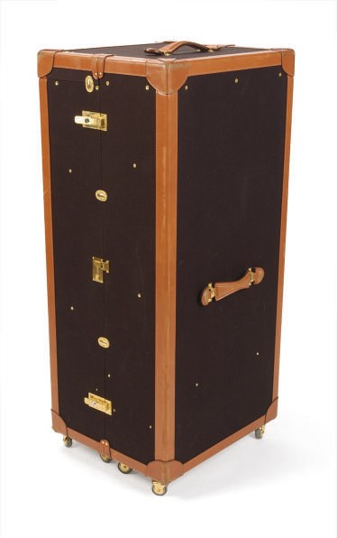A BLACK CANVAS AND TAN LEATHER TRUNK,