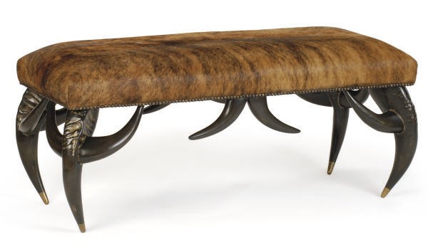 AN EBONIZED AND COWHIDE UPHOLSTERED BENCH,