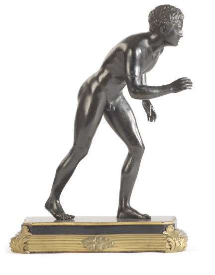 A PATINATED BRONZE FIGURE OF AN ATHLETE,