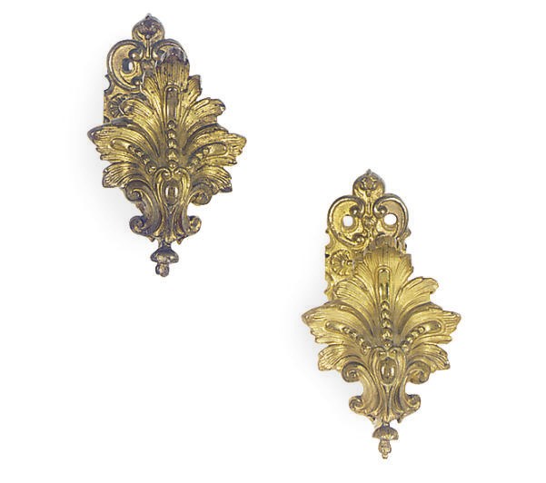 A PAIR OF ORMOLU CURTAIN TIE-BACKS,