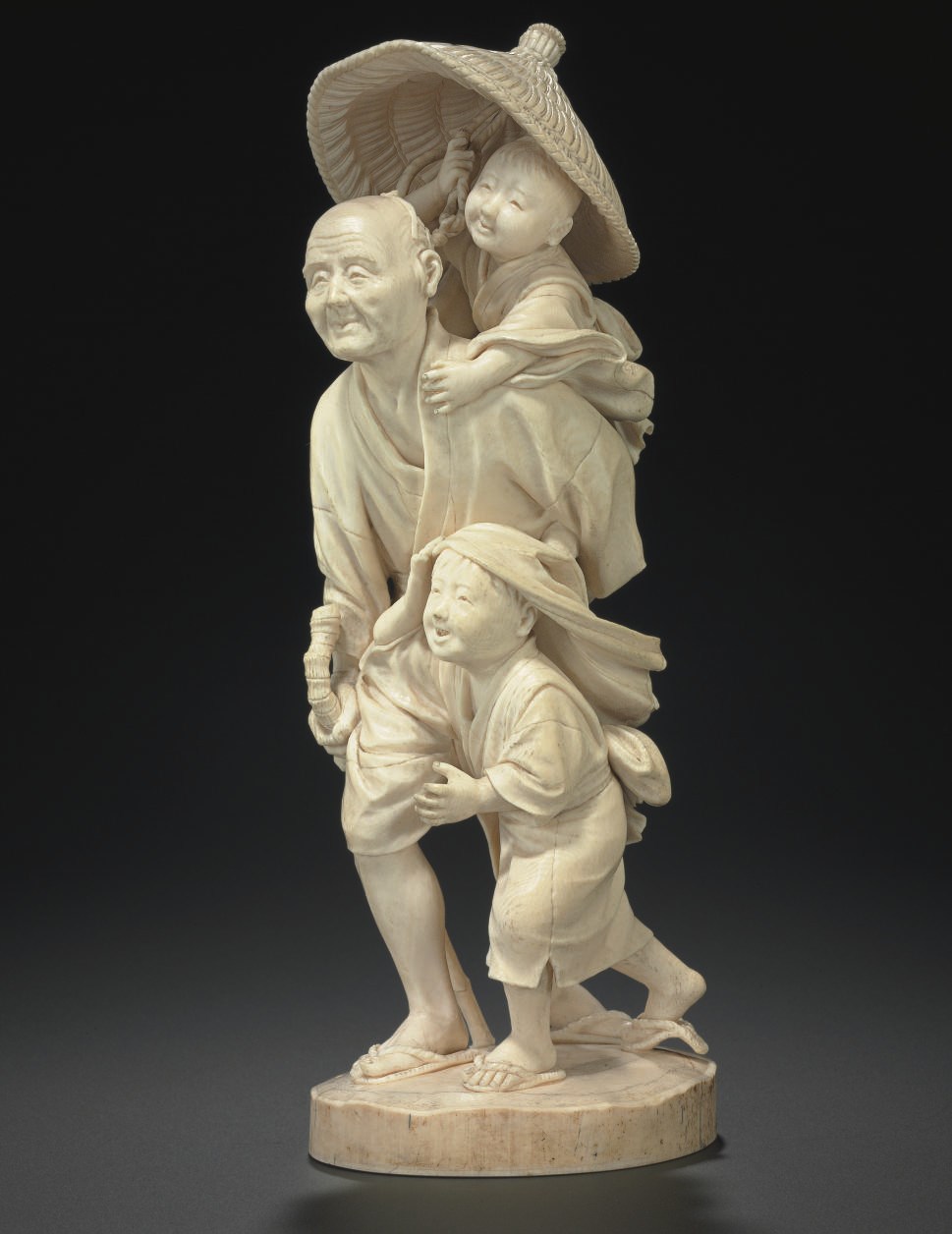 An Ivory Model of a Man and Two Boys**