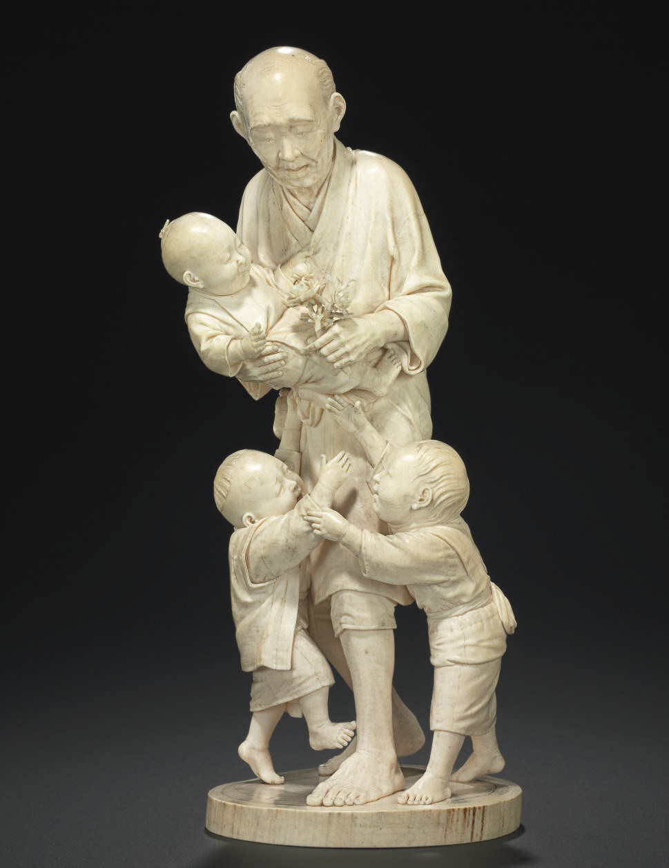 An Ivory Model of a man with Three Boys**