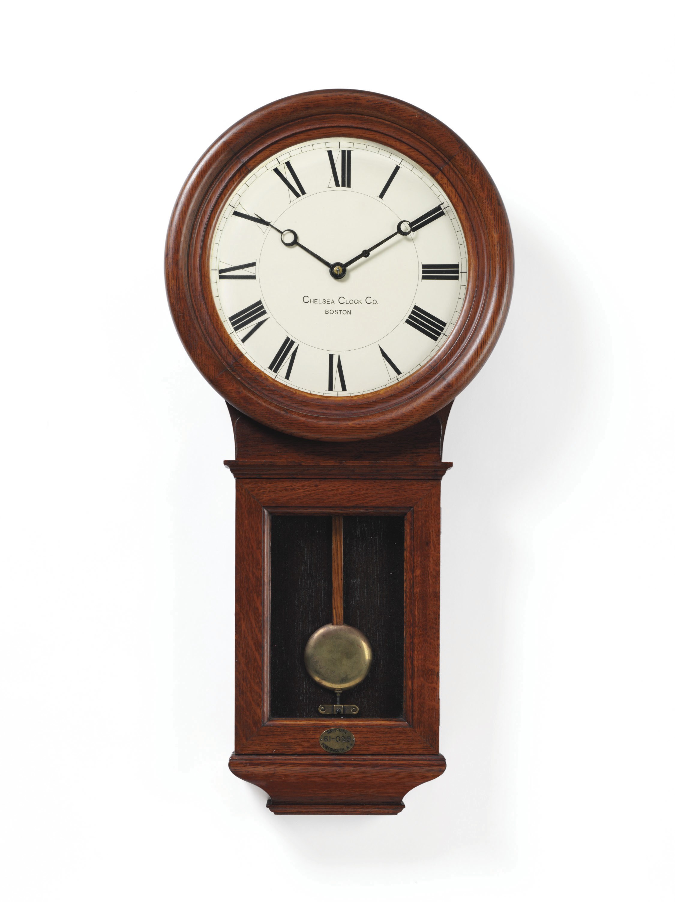 A pendulum wall clock in a mahogany case