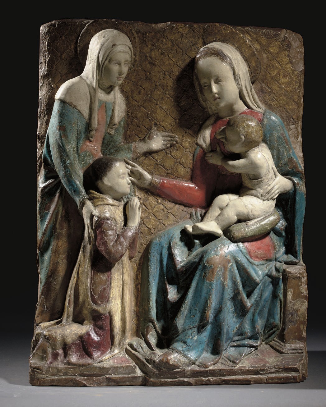 A POLYCHROME AND GILT-DECORATED TERRACOTTA RELIEF