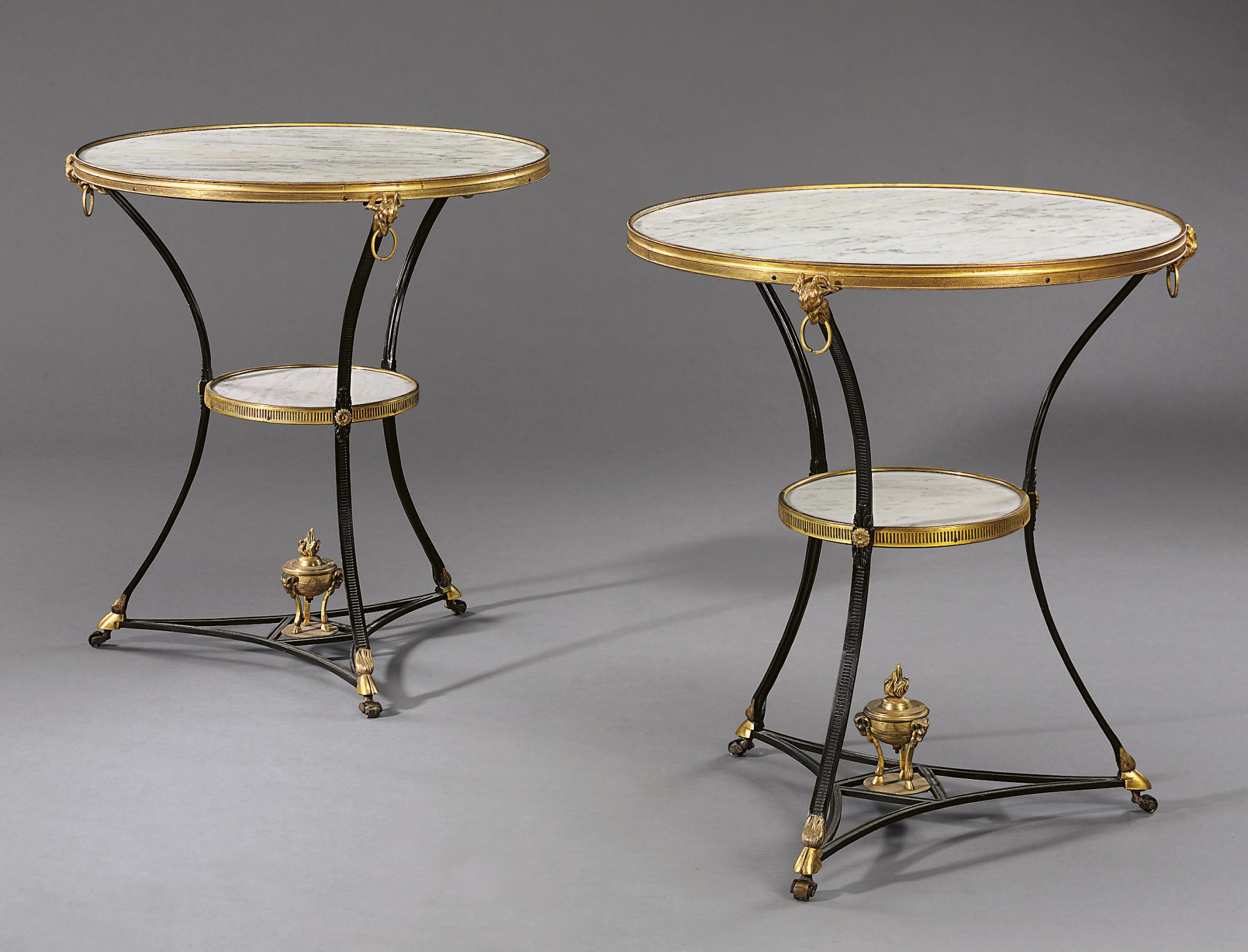 A PAIR OF ORMOLU AND EBONIZED OCCASIONAL TABLES