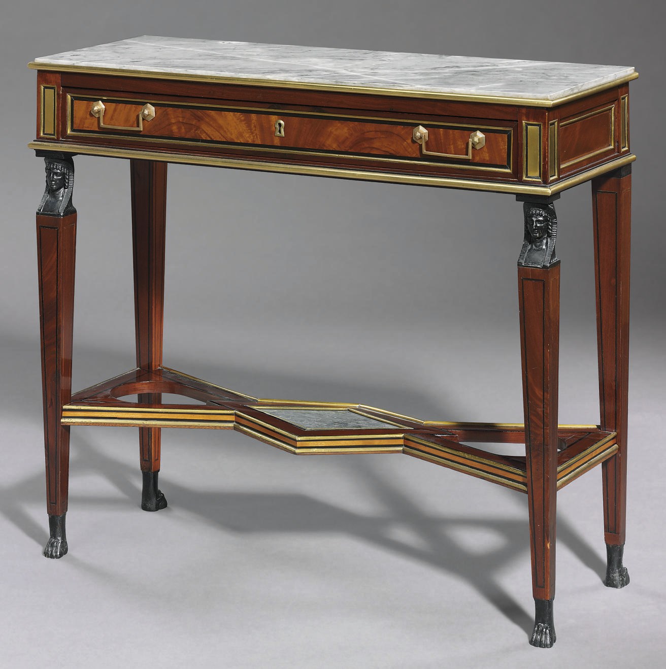 A LATE LOUIS XVI BRASS-MOUNTED MAHOGANY AND EBONIZED CONSOLE DESSERTE