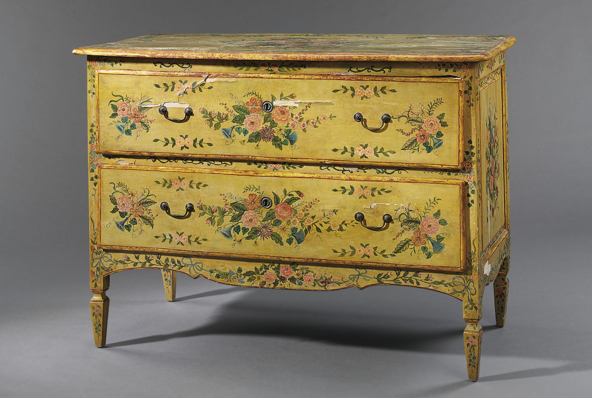 AN ITALIAN YELLOW AND POLYCHROME-PAINTED AND PARCEL-GILT COMMODE