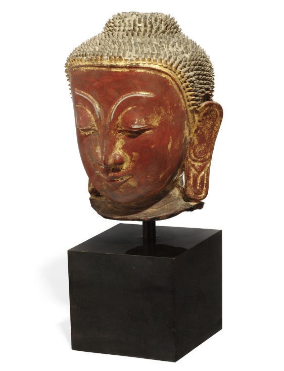 A BURMESE GILT LACQUERED POTTERY HEAD